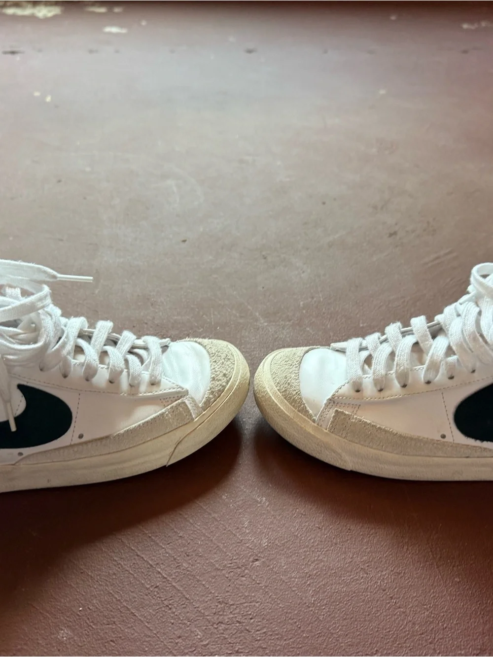 Nike White High-Top Sneakers with Black Swoosh